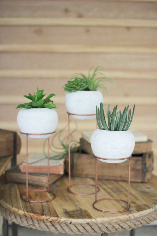 White-Washed Clay Vessels on Wire Base